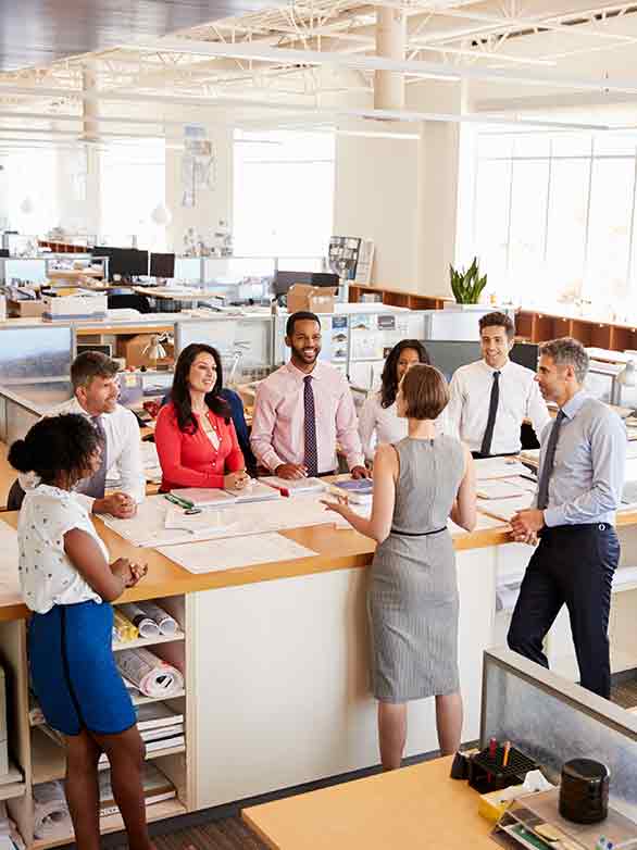 small business owner meets with employees at her growing company